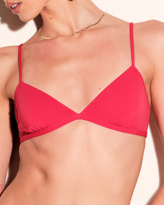A woman wearing a bright red bralette