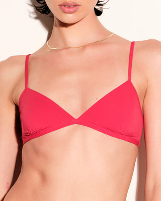 A woman wearing a bright red bralette