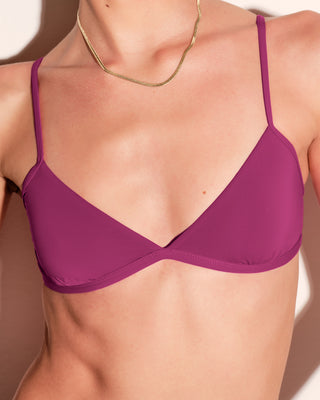 Purple bra worn by a model on a white background