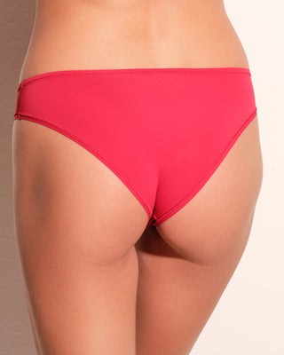 A woman wearing bright red cheeky panties