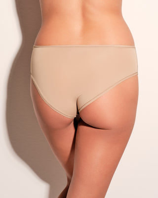 Beige underwear worn by a woman on a neutral background