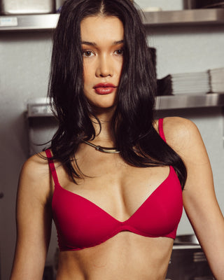 Woman wearing a red bra in an indoor setting