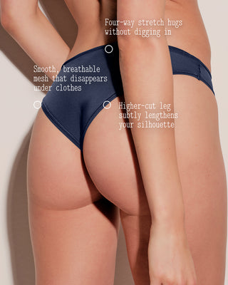 Navy blue underwear being worn on a beige background with text highlighting features.
