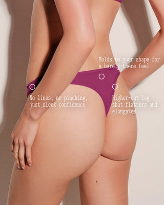 Purple underwear being worn with text describing its features on a neutral background
