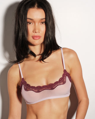 A woman wearing a pink bra with lace trim